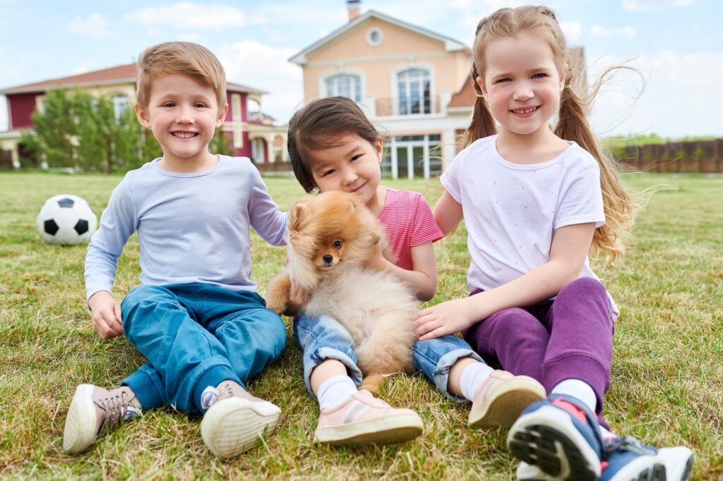 Happy Kids Playing with Puppy