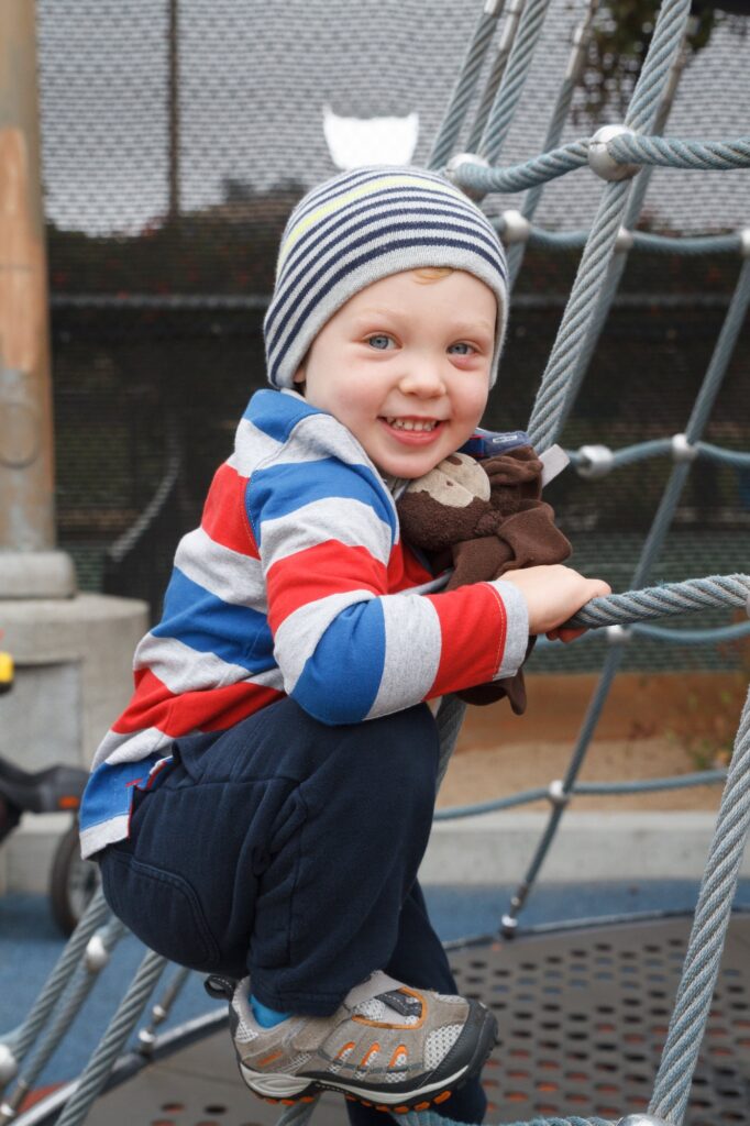 Portrait of a child child boy playing at the playground